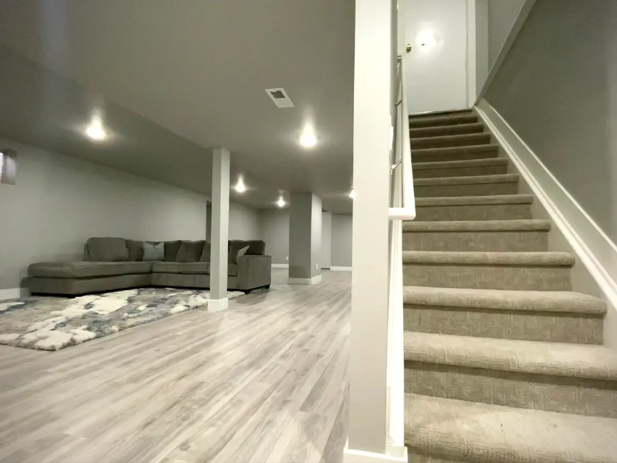 basement after renovations, gray walls, spotlights, carpet stairs, wooden floor